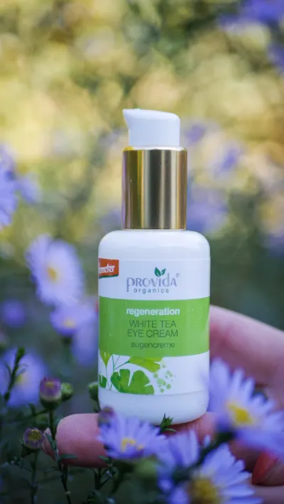 Provida White Tea oogcrème tussen paarse asters